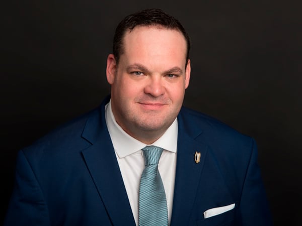 Confident LinkedIn studio headshot of financial CEO in Astoria