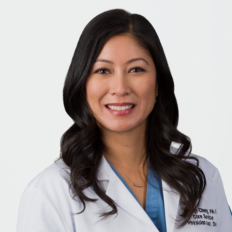 Studio headshot of a Manhattan-based female doctor photographed on a white background.